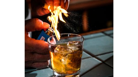 Sother Teague smoking a drink