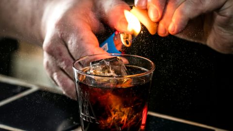 Sother Teague smoking a drink