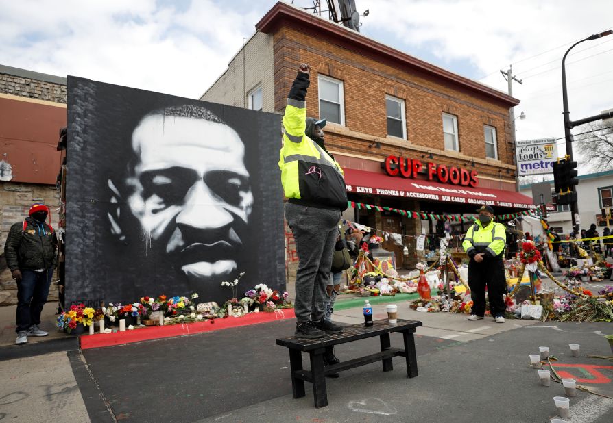 A man raises his fist in George Floyd Square ahead of the verdict announcement on April 20.