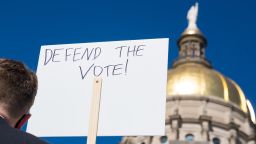 Demonstrators stand outside of the Capitol building in opposition of House Bill 531 on March 8, 2021 in Atlanta, Georgia. HB531 will restrict early voting hours, remove drop boxes, and require the use of a government ID when voting by mail.  (Photo by Megan Varner/Getty Images)