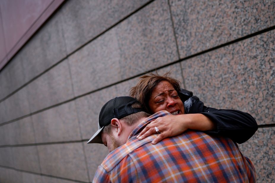 People embrace outside the Hennepin County Government Center in Minneapolis.