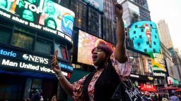 AniYa A motions as she walks through Times Square in New York, while talking on her cell phone after a Minnesota jury found Former Minneapolis police officer Derek Chauvin guilty of murder and manslaughter in the death of George Floyd, Tuesday, April 20, 2021. Floyd died last May after Chauvin, a white officer, pinned his knee on or close to the 46-year-old Black man's neck for about 9 1/2 minutes. (AP Photo/Seth Wenig)