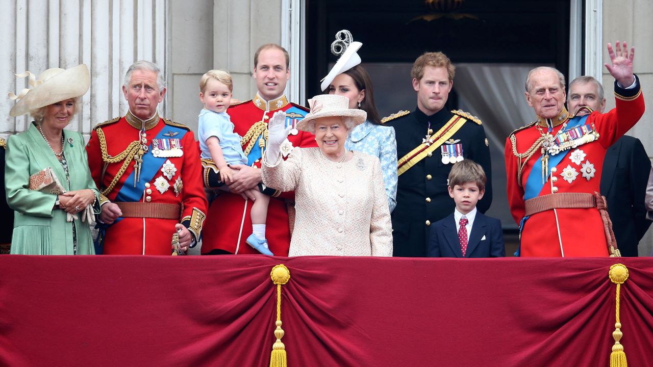 The royal family gather around Queen Elizabeth II to watch the fly-past from the balcony of Buckingham Palace following the Trooping the Colour ceremony on June 13, 2015.