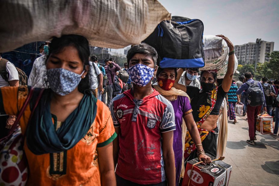 Migrant workers line up to enter a railway station ahead of a lockdown in Mumbai, India, on April 14.