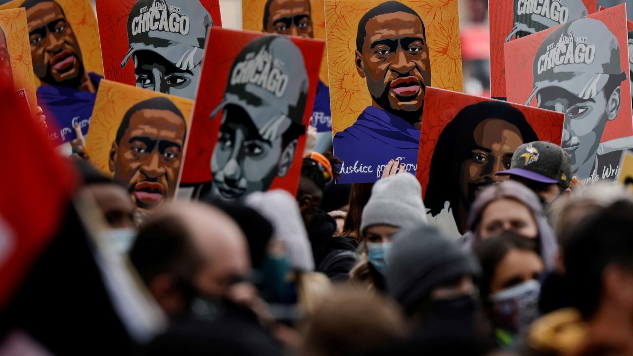People hold placards with paintings of George Floyd, Daunte Wright and Philando Castile after the verdict in the trial of former Minneapolis police officer Derek Chauvin, found guilty of the death of George Floyd, in front of Hennepin County Government Center, in Minneapolis, Minnesota, U.S., April 20, 2021. REUTERS/Carlos Barria