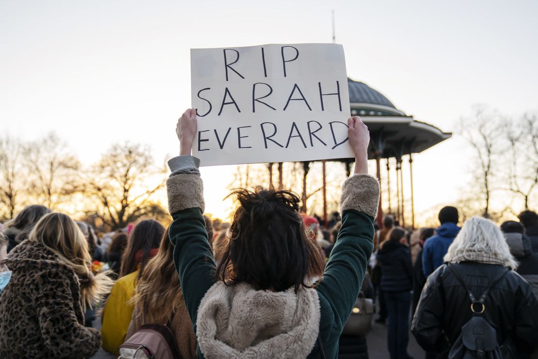 A mourner at the Clapham Common bandstand holds a sign as part of a vigil for Sarah Everard, a 33-year-old woman, whose killing has reignited a national debate on women's safety and sexual assault.