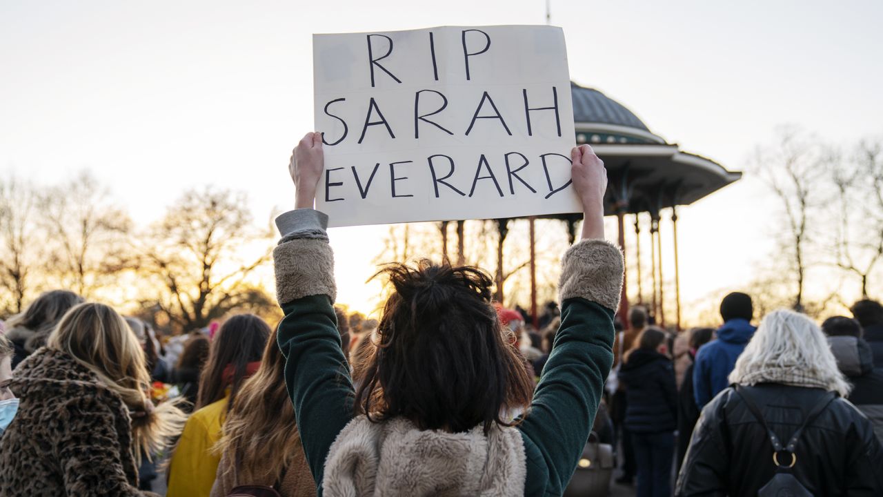 A mourner at the Clapham Common bandstand holds a sign as part of a vigil for Sarah Everard, a 33-year-old woman, whose killing has reignited a national debate on women's safety and sexual assault.