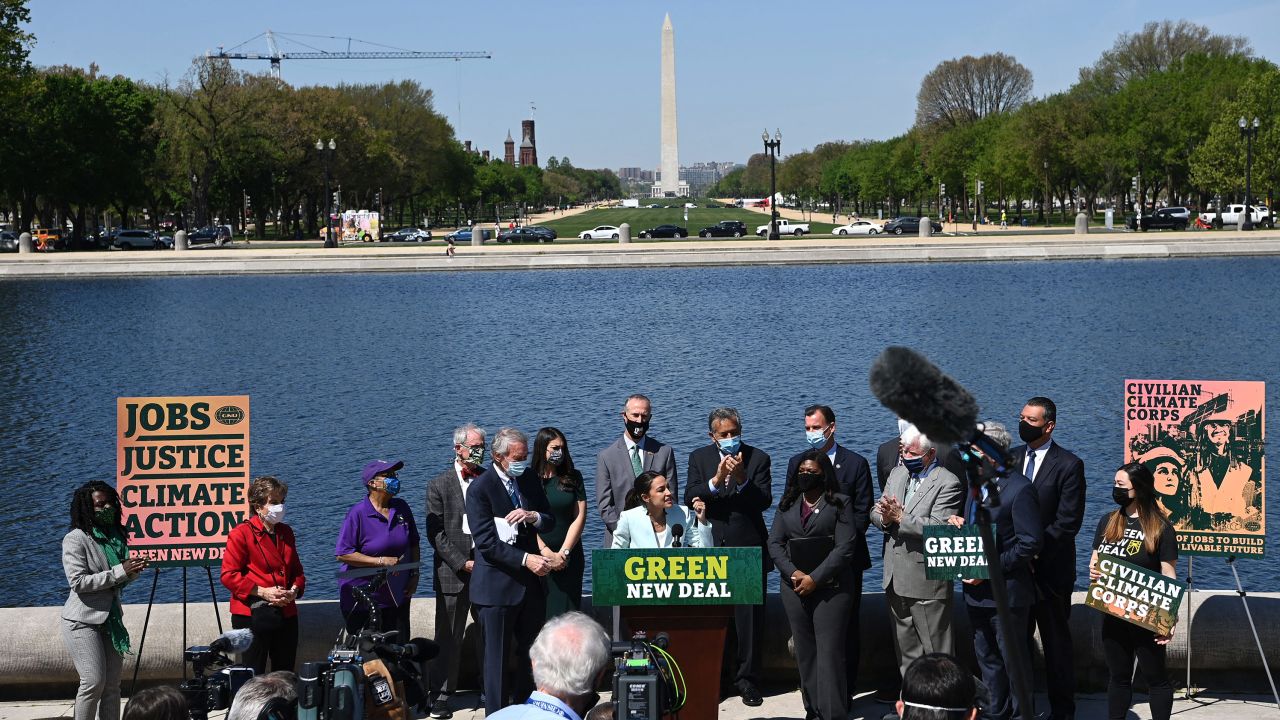 Ellen Sciales (right) joins Representative Alexandria Ocasio-Cortez(D-NY) and Senator Ed Markey, D-MA, during a press conference to re-introduce the Green New Deal in front of the US Capitol in Washington, DC on April 20, 2021. 
