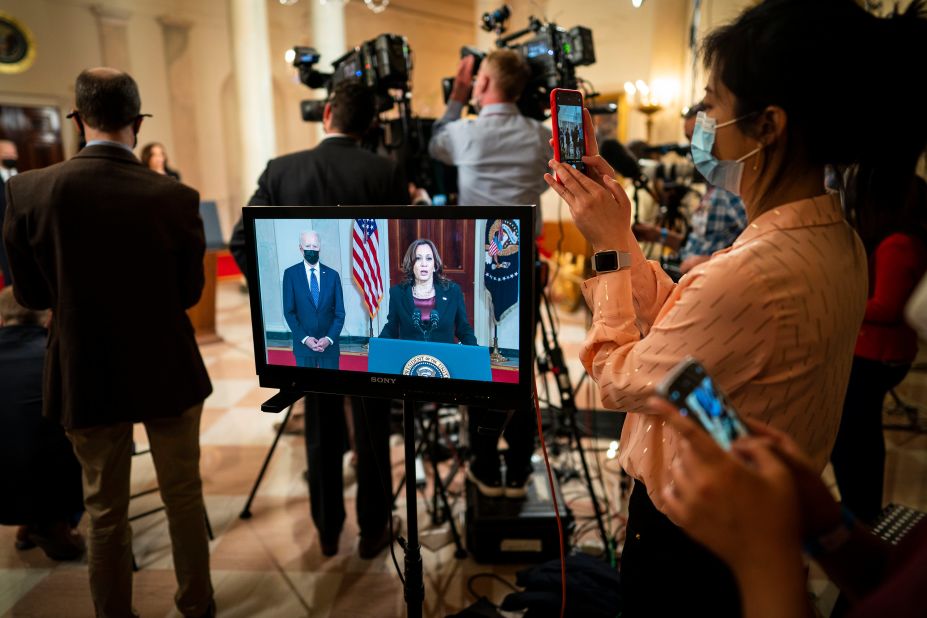 Vice President Kamala Harris is seen on a monitor making remarks about the verdict in Chauvin's trial as President Joe Biden looks on at the White House on April 20.