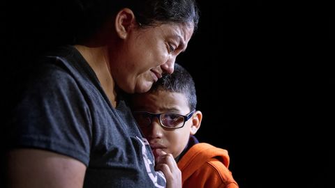An immigrant mother and son, 10, weep after completing their monthlong journey from Honduras to the US on April 14, 2021, in Roma, Texas.