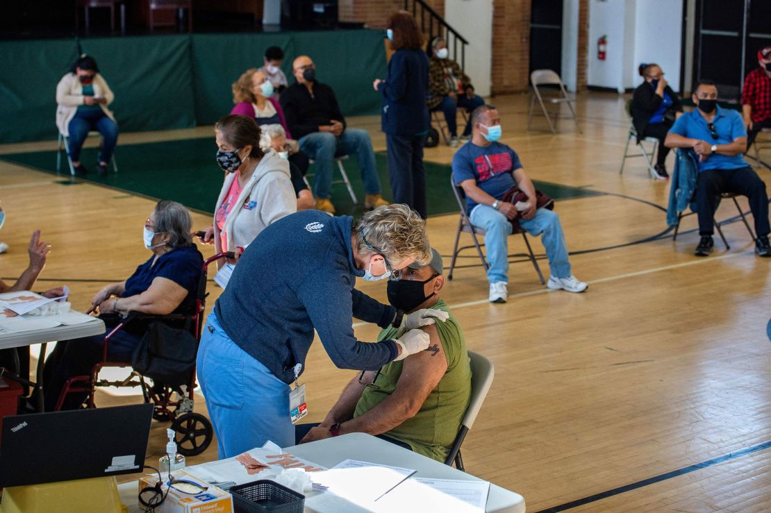 People receive their second dose of the vaccine at a mobile Covid-19 vaccination clinic in Bridgeport, Connecticut, on Tuesday.