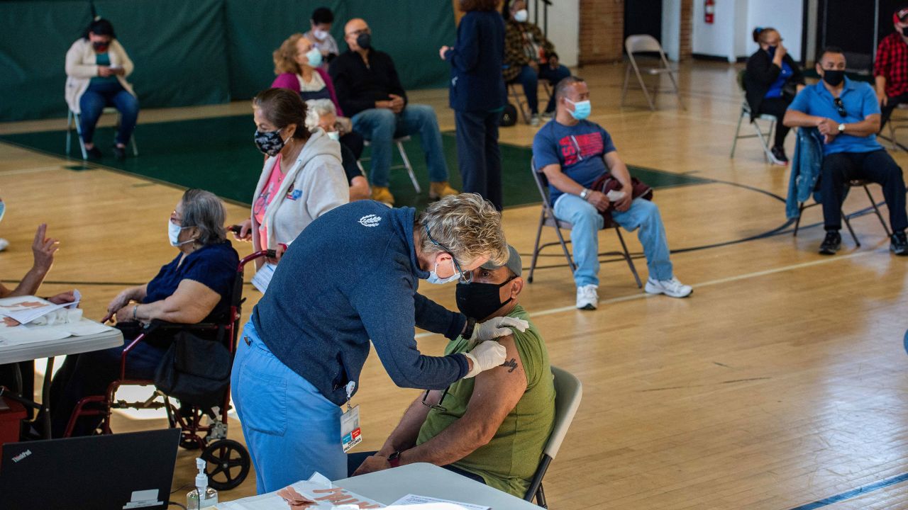People receive their second dose of the vaccine at a mobile Covid-19 vaccination clinic in Bridgeport, Connecticut, on Tuesday.
