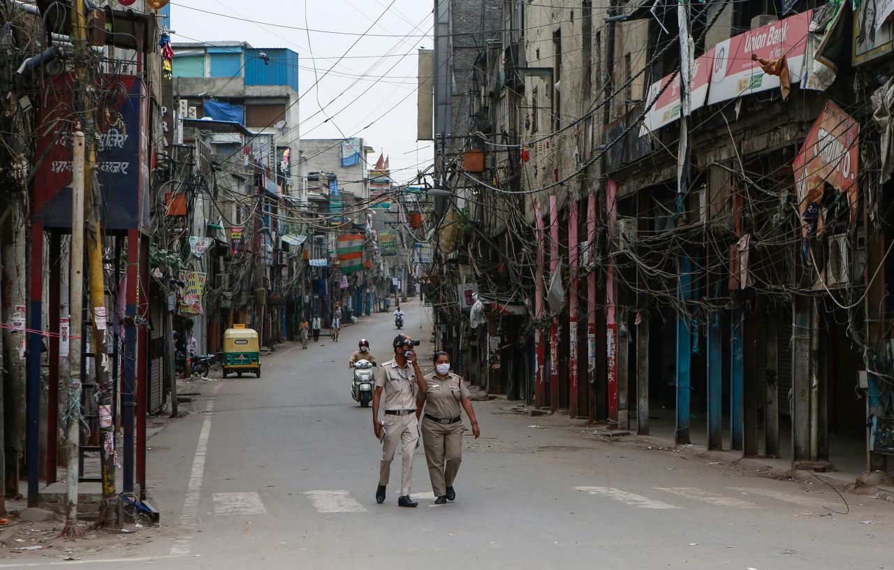 Police officers patrol a deserted street in New Delhi on April 20. The capital city has been on lockdown because of Covid-19.