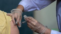A medical staff member administers a dose of the Moderna Covid-19 vaccine at a pop up vaccine clinic at the Jewish Community Center on April 16, 2021 in the Staten Island borough of New York City. (Photo by Angela Weiss/AFP/Getty Images)