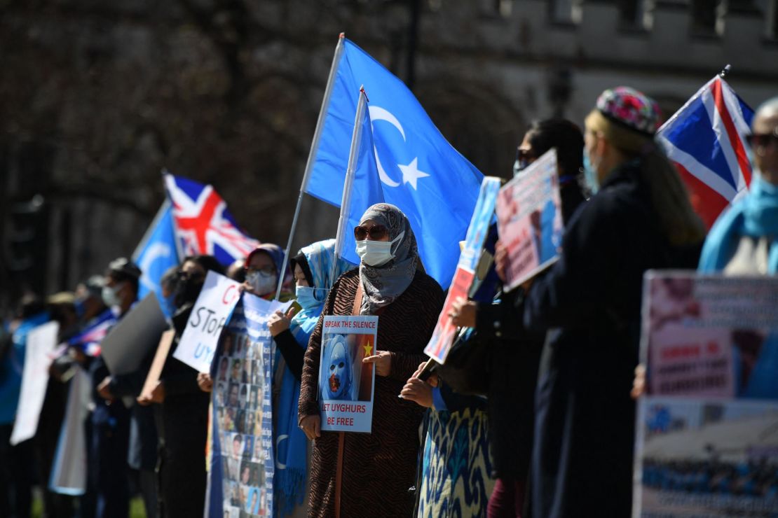 Members of the Uyghur community urge the British Parliament to vote to recognize alleged persecution of China's Muslim minority Uyghur people as genocide and crimes against humanity in London on April 22, 2021.