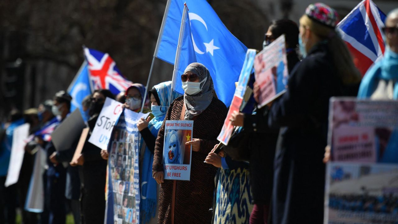 Members of the Uyghur community urge the British Parliament to vote to recognize alleged persecution of China's Muslim minority Uyghur people as genocide and crimes against humanity in London on April 22, 2021.