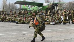 A Russian paratrooper walks as other wait to be load into a plane for airborne drills during maneuvers in Taganrog, Russia, Thursday, April 22, 2021. Russia's defense minister on Thursday ordered troops back to their permanent bases following massive drills amid tensions with Ukraine, but said that they should leave their weapons behind in western Russia for another exercise later this year. (AP Photo)