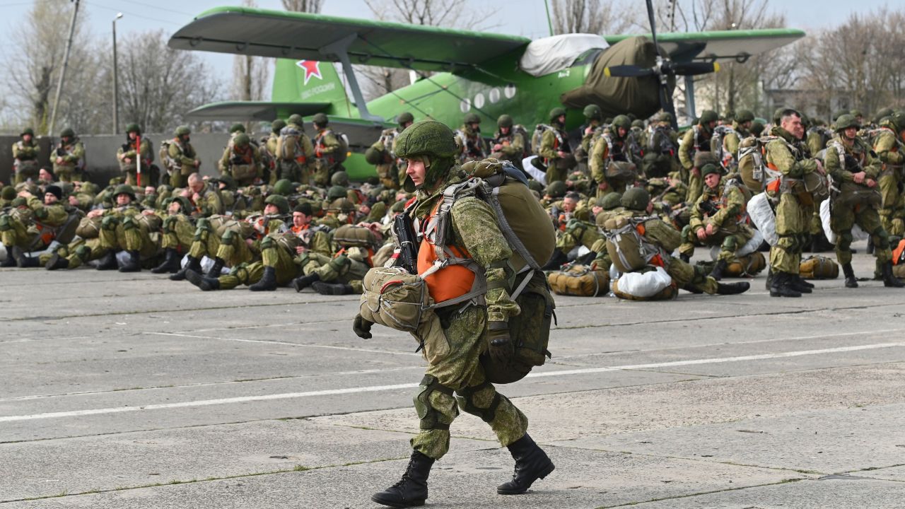 A Russian paratrooper walks near a plane during maneuvers in Taganrog, Russia, on Thursday, April 22, 2021. 