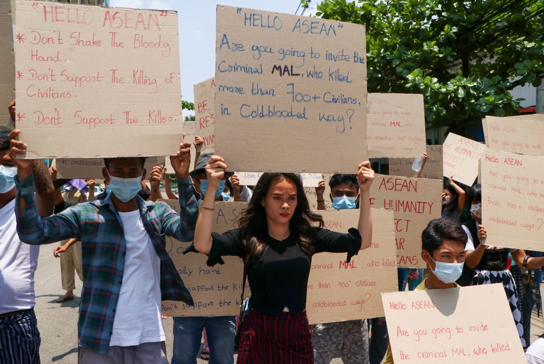 Anti-coup protesters hold slogans calling the attention of an ASEAN regional meeting during a rally on April 20, 2021 in Yangon, Myanmar. 