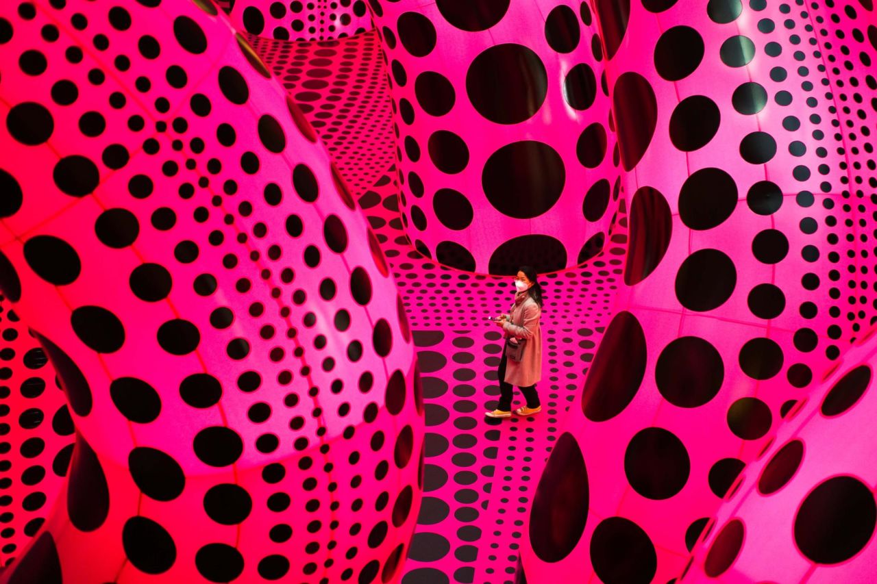 A woman walks through the artwork "A Bouquet of Love I Saw in the Universe" by Yayoi Kusama during a press preview of the artist's exhibition at the Martin Gropius Bau museum in Berlin, Germany, on April 22. 