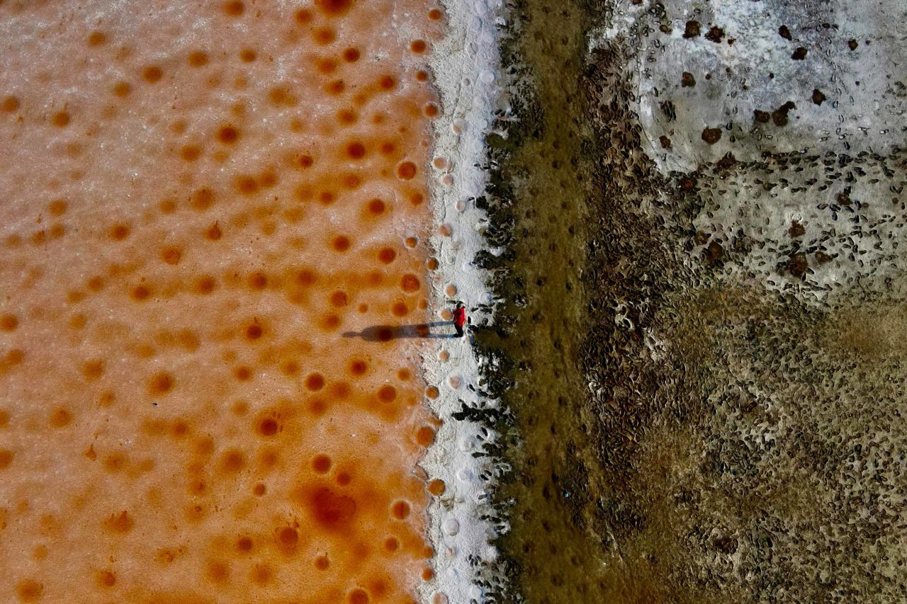 A man walks along salt fields in Tainan, Taiwan, on Wednesday, April 21.
