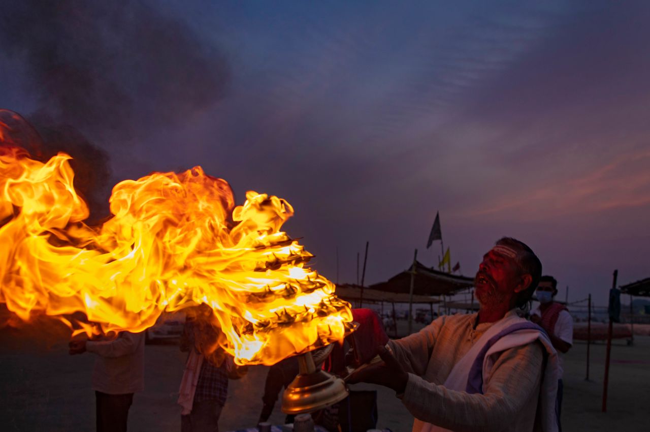 A Hindu priest rotates oil lamps for an arati ritual during Rama Navami in Prayagraj, India, on Wednesday, April 21. Rama Navami is a spring festival that celebrates the birth of the Hindu god Rama.