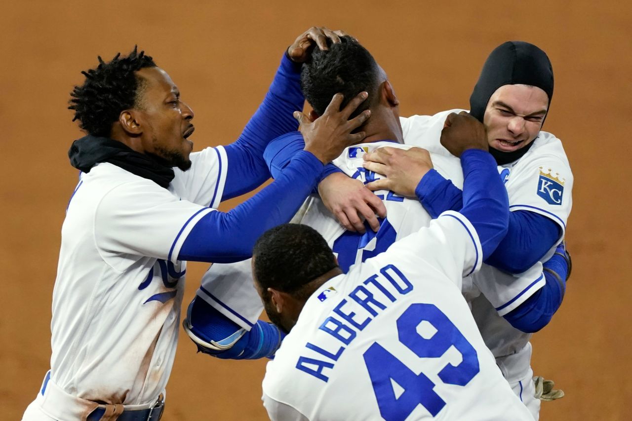 Kansas City Royals' Salvador Perez, top center, celebrates with teammates after hitting a single to drive in the winning run during the ninth inning of the game against the Tampa Bay Rays on Wednesday, April 21, in Kansas City, Missouri. The Royals won 9-8.