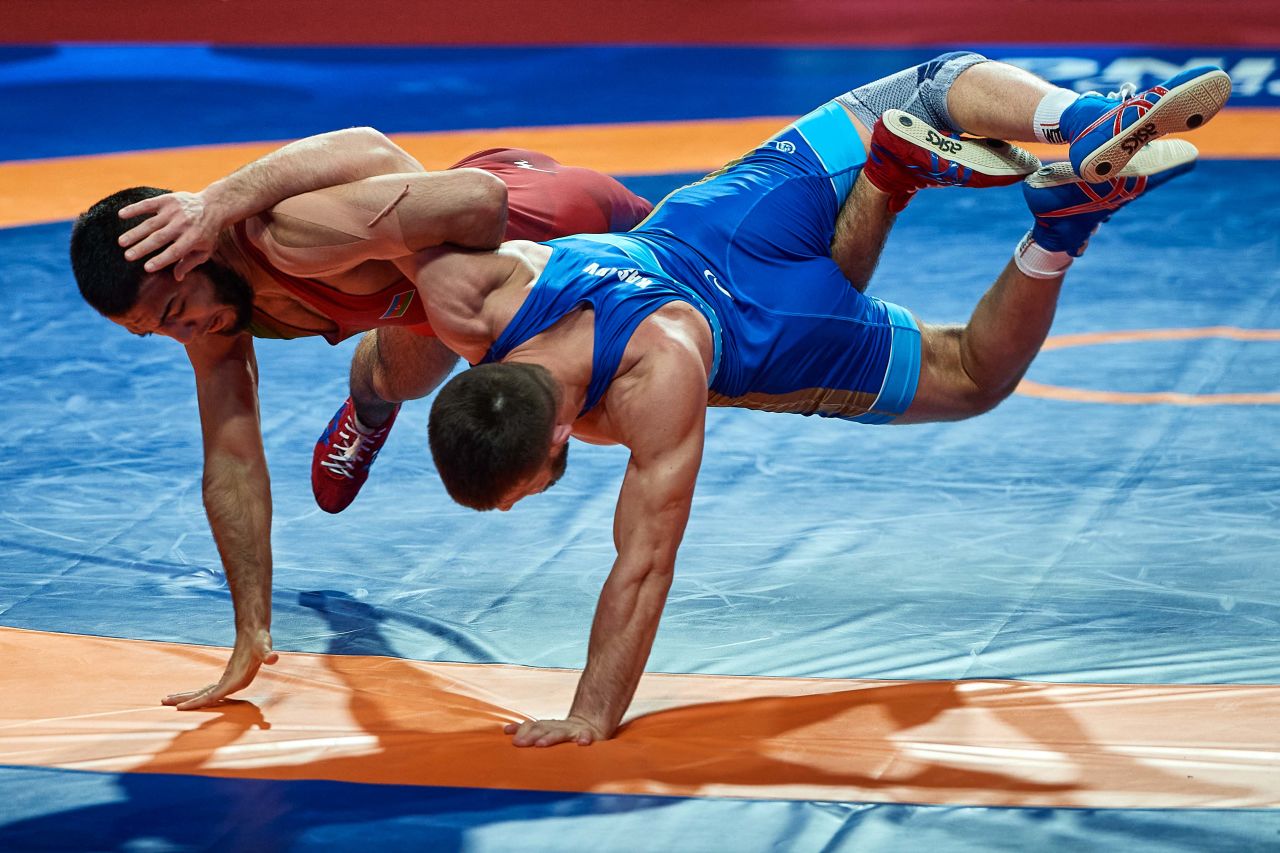 Azerbaijan's Turan Bayramov, left, fights with Russia's Israil Kasumov during the United World Wrestling Senior European Championships in Warsaw, Poland, on April 20.