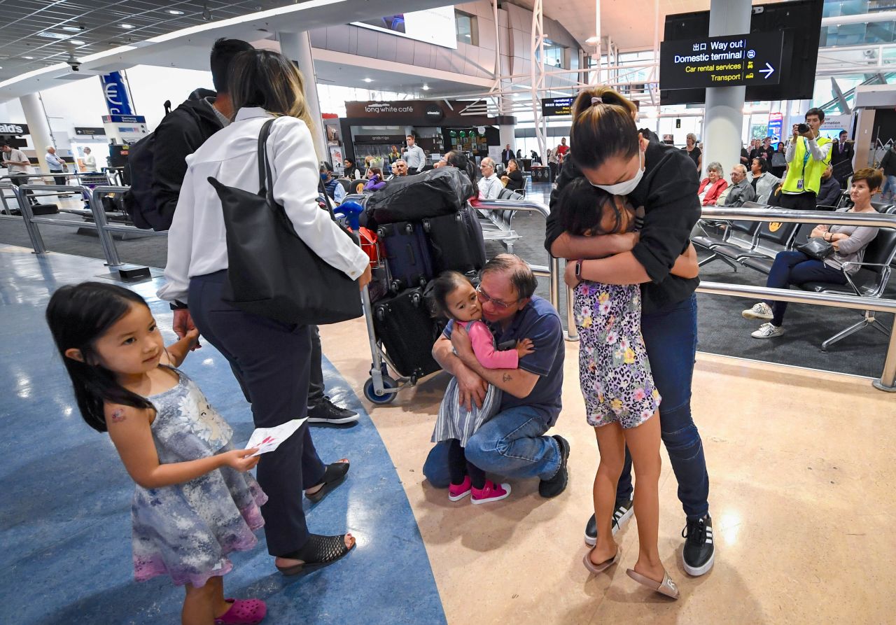 Passengers from Australia are greeted by friends and relatives at the Auckland Airport on Monday, April 19, in Auckland, New Zealand. The <a href="https://www.cnn.com/travel/article/australia-new-zealand-travel-bubble-intl-hnk/index.html" target="_blank">two-way travel bubble between Australia and New Zealand opened</a> on Monday, allowing passengers to move quarantine-free between both countries for the first time in more than a year. 