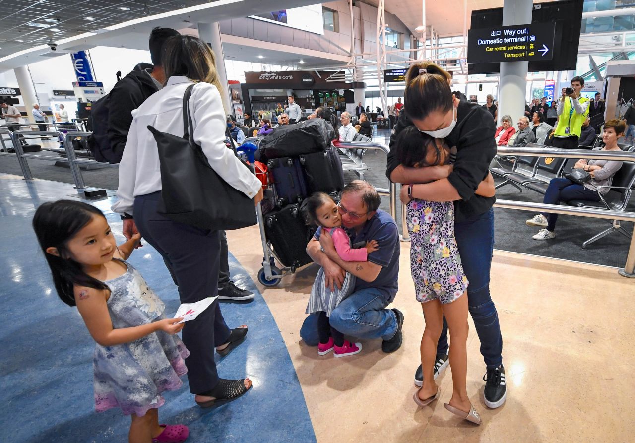 Passengers from Australia are greeted by friends and relatives at the Auckland Airport on Monday, April 19, in Auckland, New Zealand. The <a href="https://www.cnn.com/travel/article/australia-new-zealand-travel-bubble-intl-hnk/index.html" target="_blank">two-way travel bubble between Australia and New Zealand opened</a> on Monday, allowing passengers to move quarantine-free between both countries for the first time in more than a year.