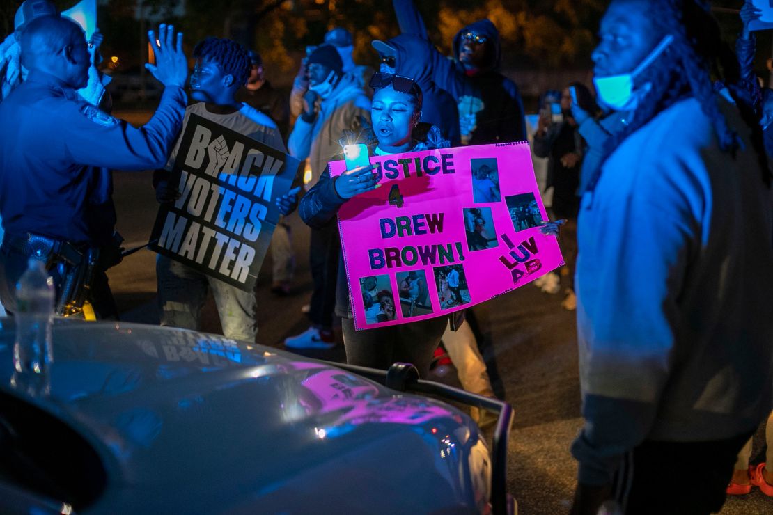 Police try to get  demonstrators to move after they surrounded an Elizabeth City police car on Thursday night.
