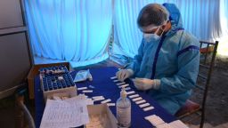 A health worker prepares a Covid-19 test sample at a testing centre in Srinagar, Indian Administered kashmir on 21 April 2021. India reported the highest one day increase with 2,94,115 Covid-19 cases and a record of 2020 new deaths, while as Jammu and Kashmir reported 2204 new cases and 13 new deaths. (Photo by Muzamil Mattoo/NurPhoto via Getty Images)