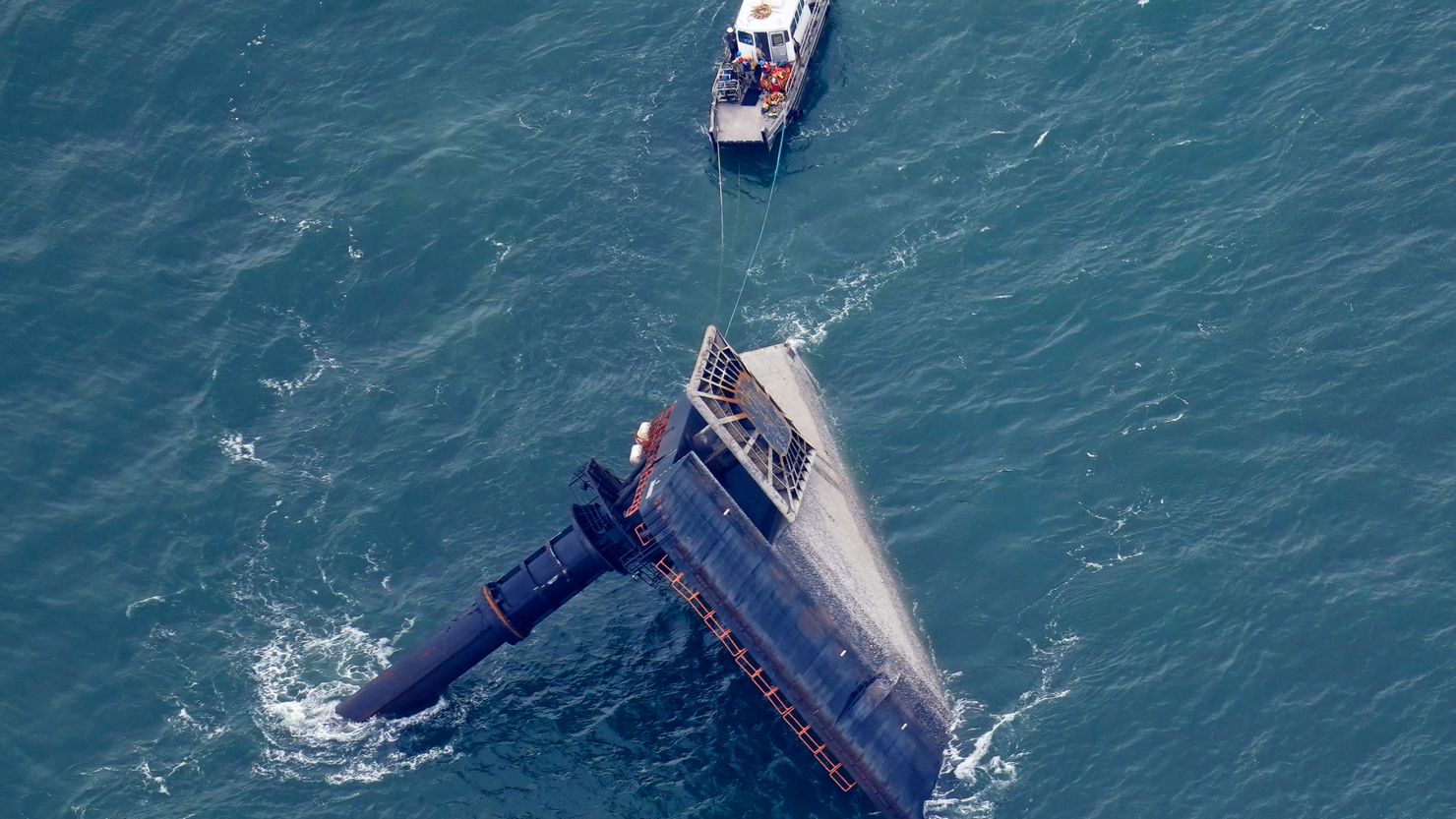A rescue boat is seen next to the capsized lift boat Seacor Power seven miles off the coast of Louisiana in the Gulf of Mexico Sunday, April 18, 2021.