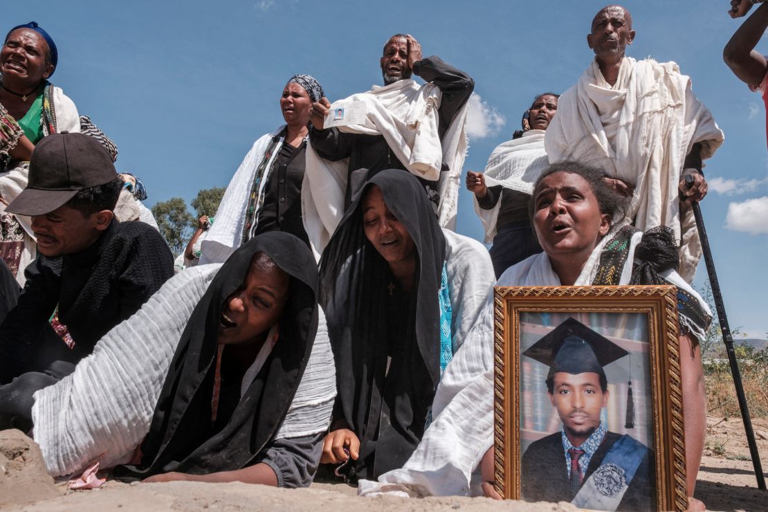 Tigrayans grieve by a mass grave in the city of Wukro, north of Mekele, on February 28, 2021.  