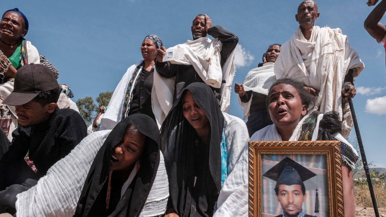 Tigrayans grieve by a mass grave in the city of Wukro, north of Mekele, on February 28, 2021.  