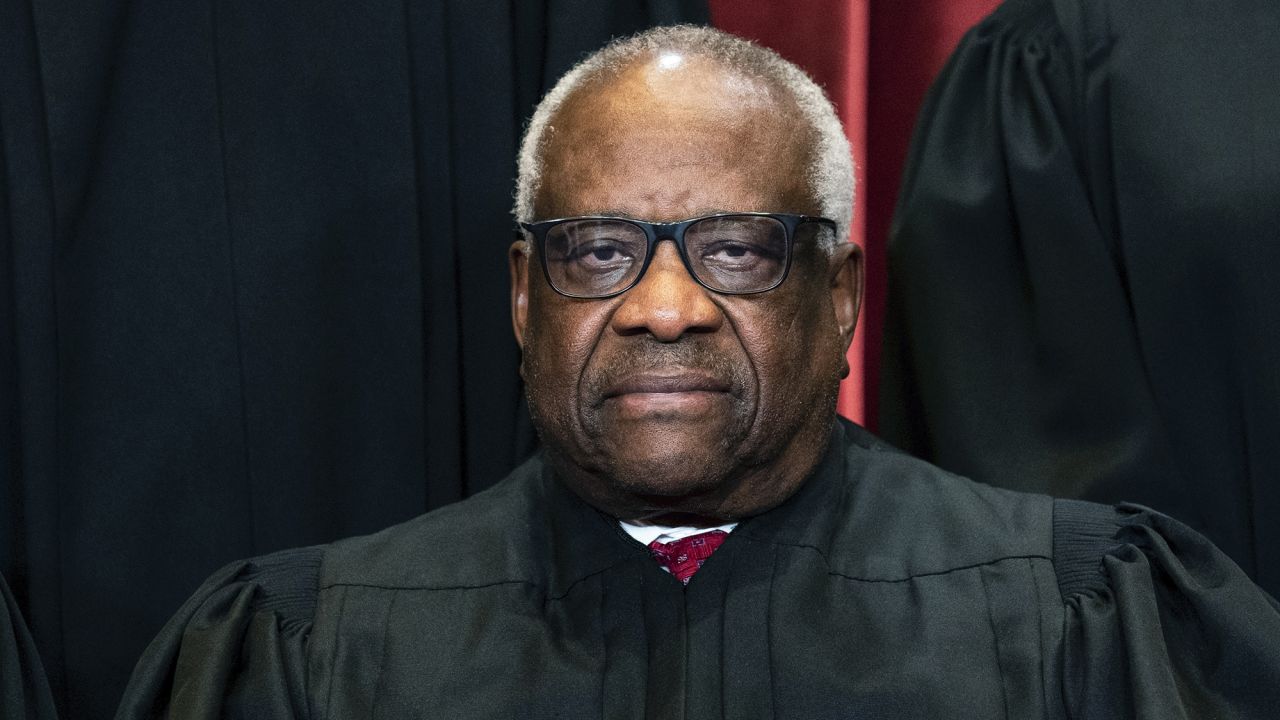 Associate Justice Clarence Thomas sits during a group photo at the Supreme Court 