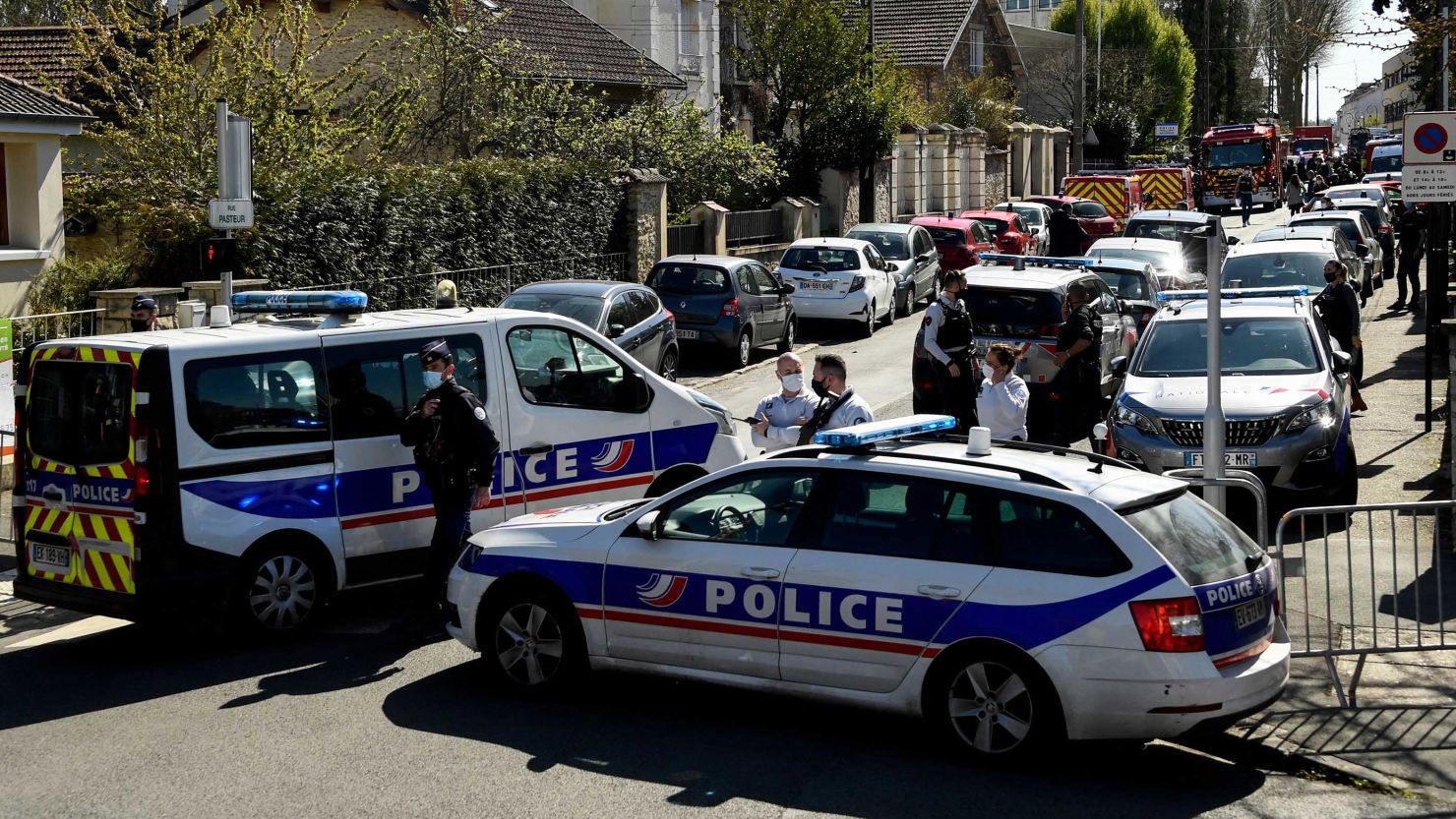 French police officials block off a street near a police station in Rambouillet, southwest of Paris.