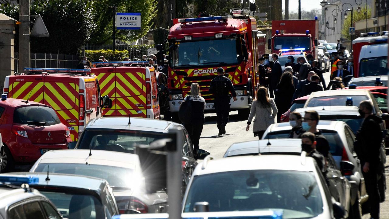 French police officials and firefighters at the station in Rambouillet.