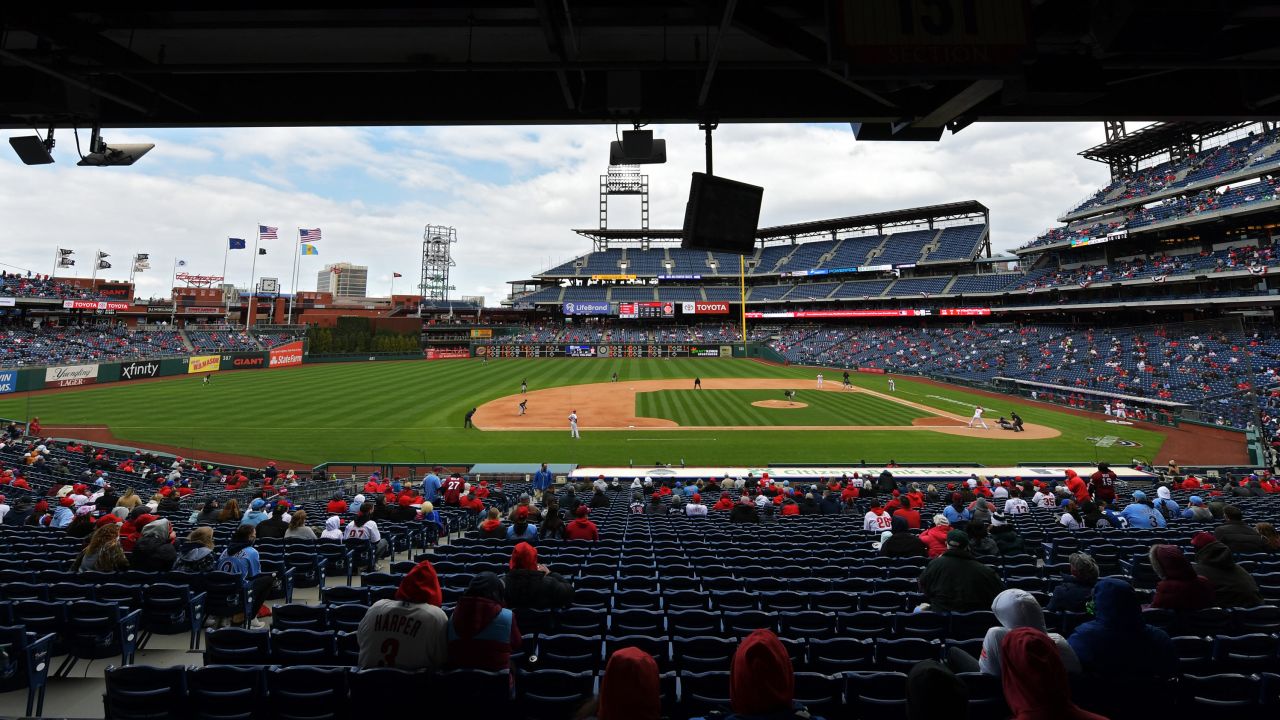 Some attendees physical distance while watching a baseball game between the Atlanta Braves and Philadelphia Phillies on opening day at Citizens Bank Park in Philadelphia on April 1.