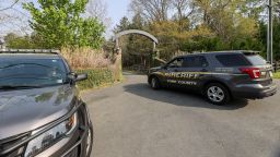 A York County sheriff vehicle drives onto the property where multiple people, including a prominent doctor, were fatally shot a day earlier, Thursday, April 8, 2021, in Rock Hill, S.C. A source briefed on the mass killing said the gunman was former NFL player Phillip Adams, who shot himself to death early Thursday. (AP Photo/Nell Redmond)