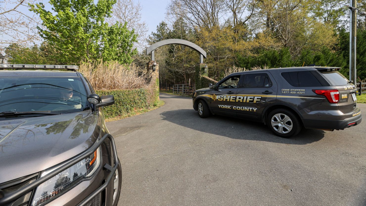 A York County sheriff vehicle drives onto the property where multiple people, including a prominent doctor, were fatally shot on April 7.