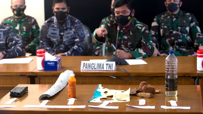 Indonesian Military chief Hadi Tjahjanto, center, talks to media as they display debris found in the waters during a search operation for the Indonesian Navy submarine KRI Nanggala at Ngurah Rai Military Air Base in Bali, Indonesia on Saturday, April 24, 2021. Indonesia's navy on Saturday said items were found from a missing submarine, indicating the vessel with 53 crew members had sank and there was no hope of finding survivors.(AP Photo/Firdia Lisnawati)