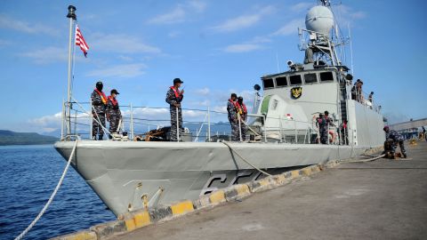 An Indonesian Navy patrol boat prepares to leave a naval base in Banyuwangi, East Java province, on Saturday, as the military continues search operations off the coast of Bali for the missing submarine.