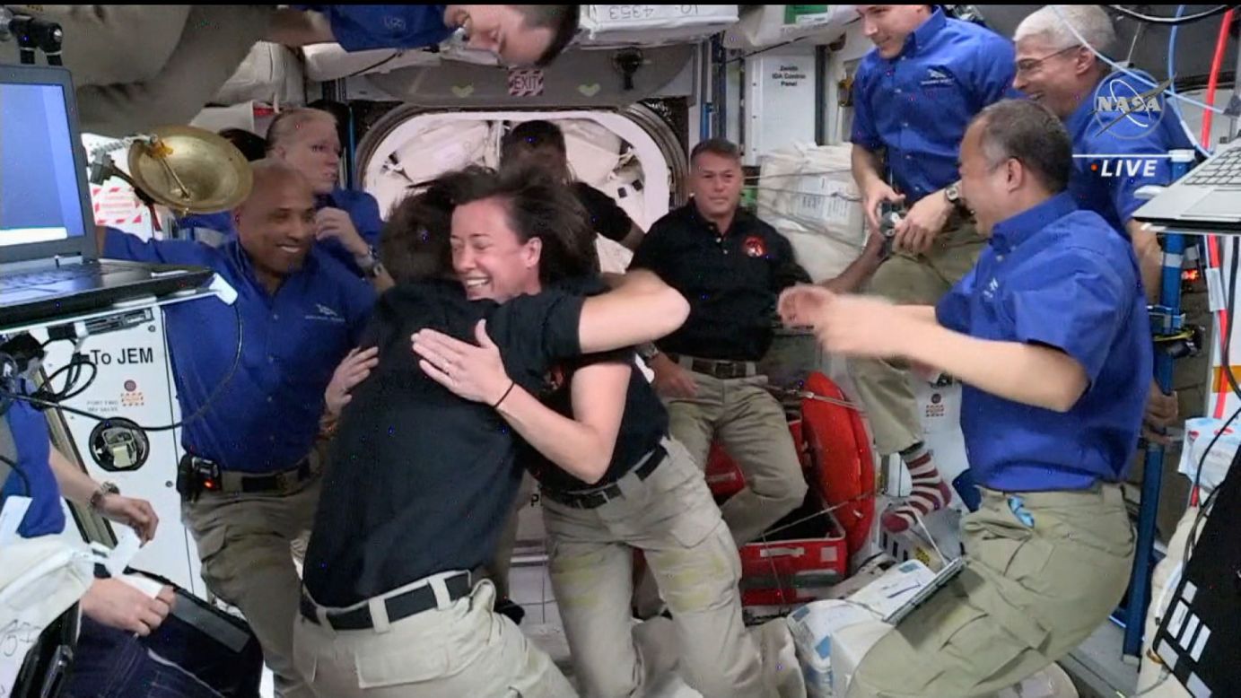 Astronauts greet one another on the International Space Station after a SpaceX capsule successfully docked Saturday, April 24. The spacecraft brought four new astronauts to the ISS.