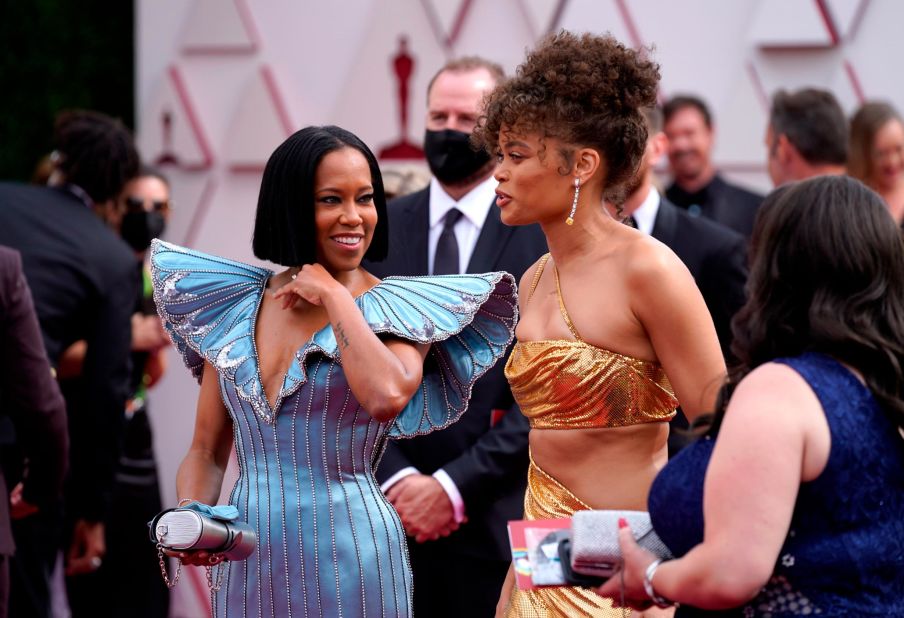 Wearing Louis Vuitton, "One Night in Miami..." director Regina King, left, walks the red carpet near Andra Day. King opened the show and presented the first two awards.