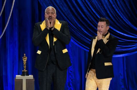 Travon Free, left, and Martin Desmond Roe accept the Oscar for the short film "Two Distant Strangers." Their shoes and the inside of their jackets carried the names of George Floyd, Breonna Taylor and other people killed by police violence.