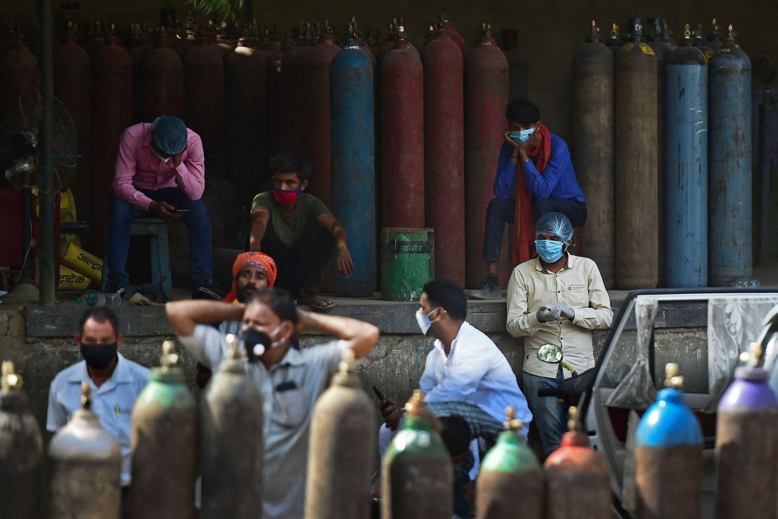 People wait to refill medical oxygen cylinders at an oxygen refilling station in Allahabad, India, on April 24.