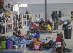 Internally displaced people (IDP) from Palma gather in the Pemba Sports center to receive humanitarian aid in Pemba on April 2, 2021. - People were evacuated from the coasts of Palma after armed insurgents attacked the city on March 24, 2021. 