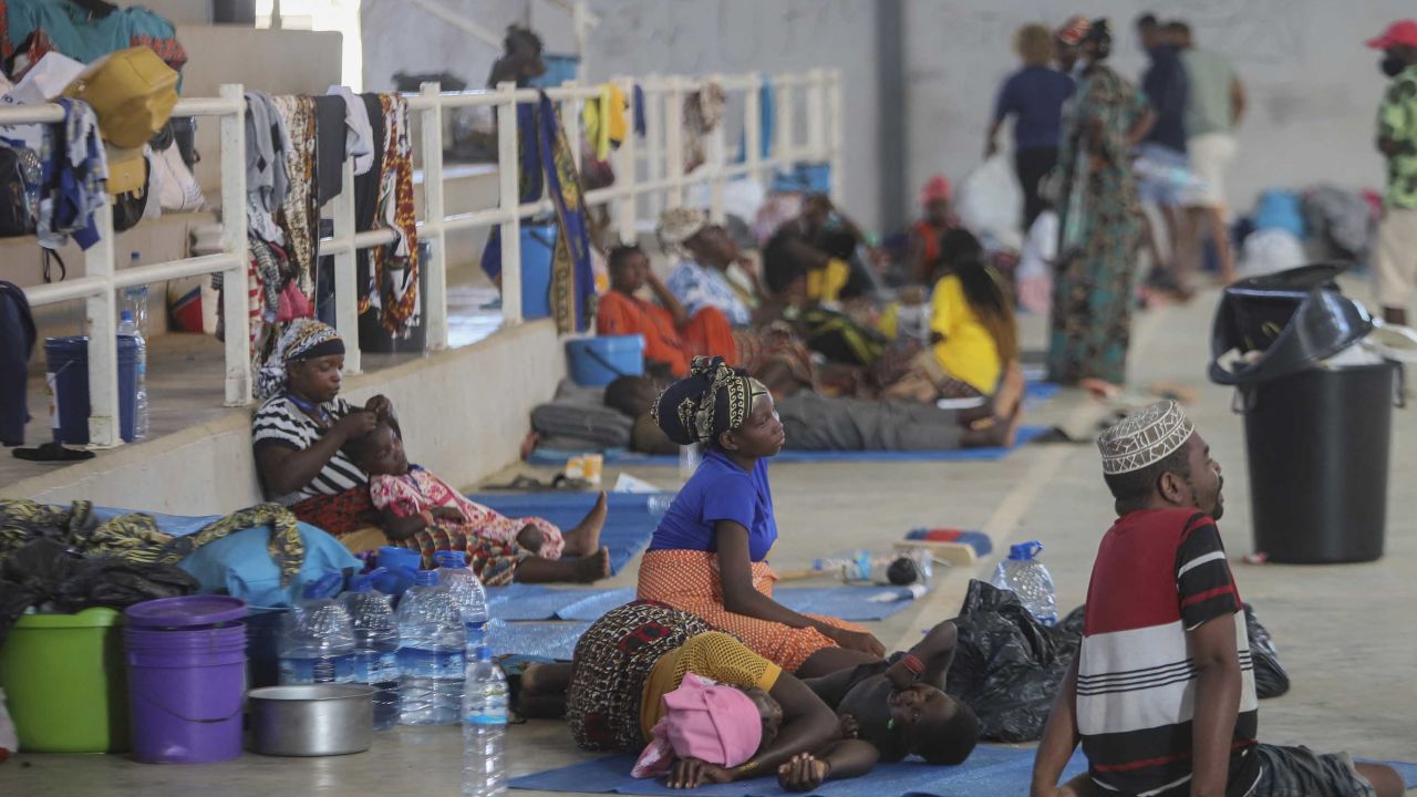 Internally displaced people (IDP) from Palma gather in the Pemba Sports center to receive humanitarian aid in Pemba on April 2, 2021. - People were evacuated from the coasts of Palma after armed insurgents attacked the city on March 24, 2021. 