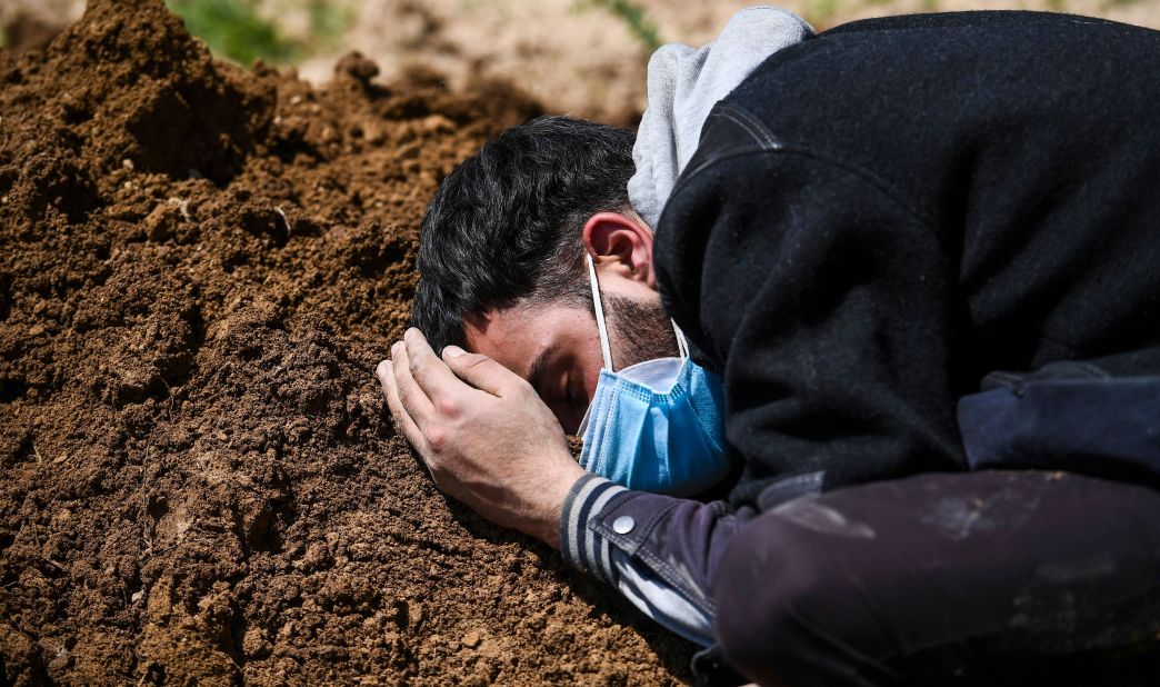 Umar Farooq mourns at the grave of his mother, a Covid-19 victim, in Srinagar.